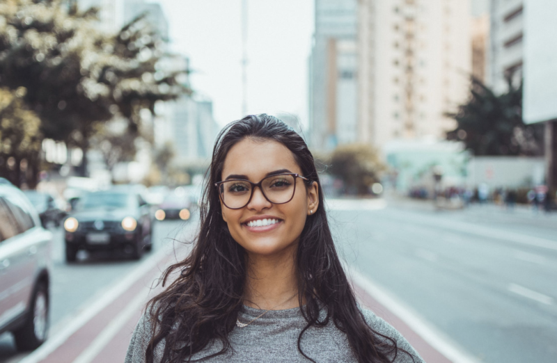 Smiling woman shows effect of teeth whitening treatment