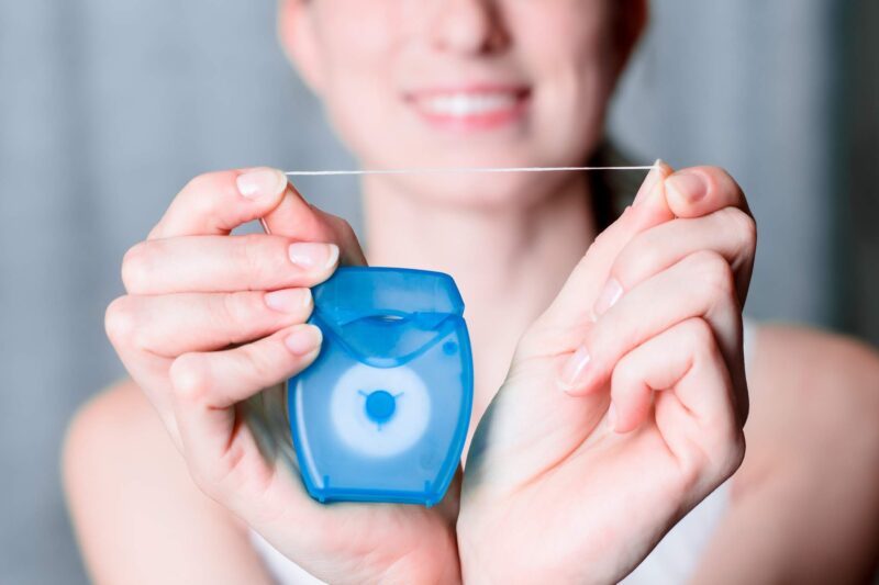 woman holding floss