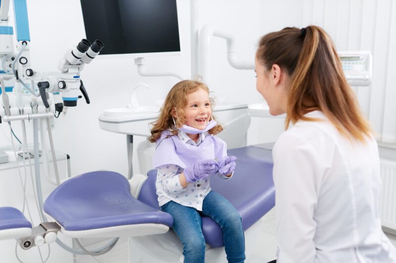 child and dentist at an appointment