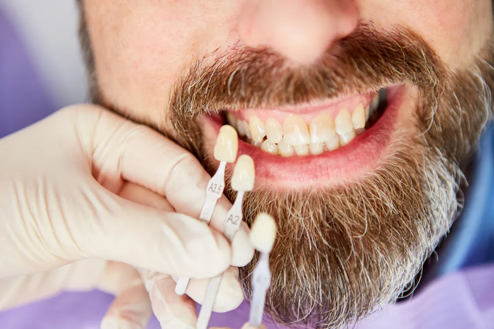 1. A bearded man holding a toothbrush, preparing to brush his teeth.